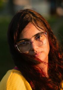 Captivating outdoor portrait of a young woman during golden hour, highlighting natural beauty.